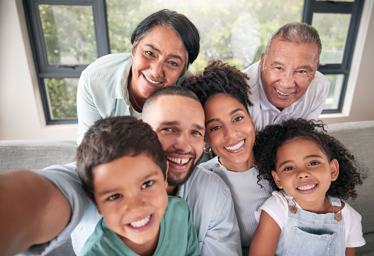 Diverse family smiling together, illustrating eye health tips by age for all generations