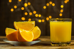 Fresh oranges and orange juice rich in vitamin C to support eye health.