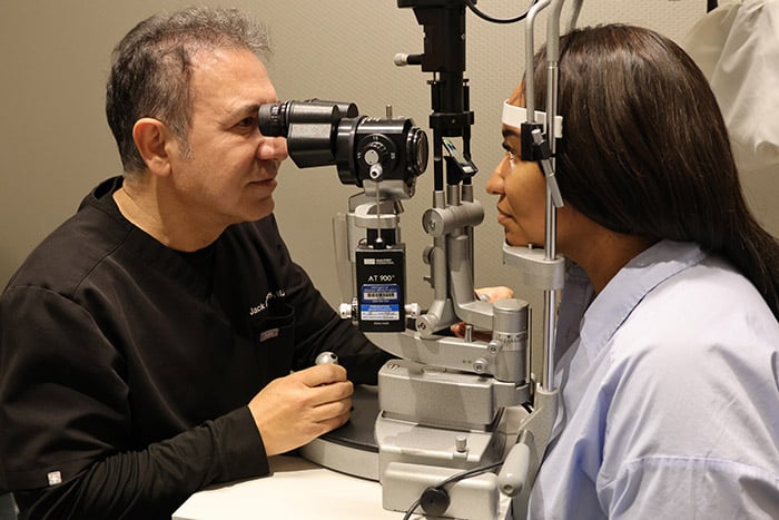 Dr. Abrams giving LASIK exam and checking health of the eye.