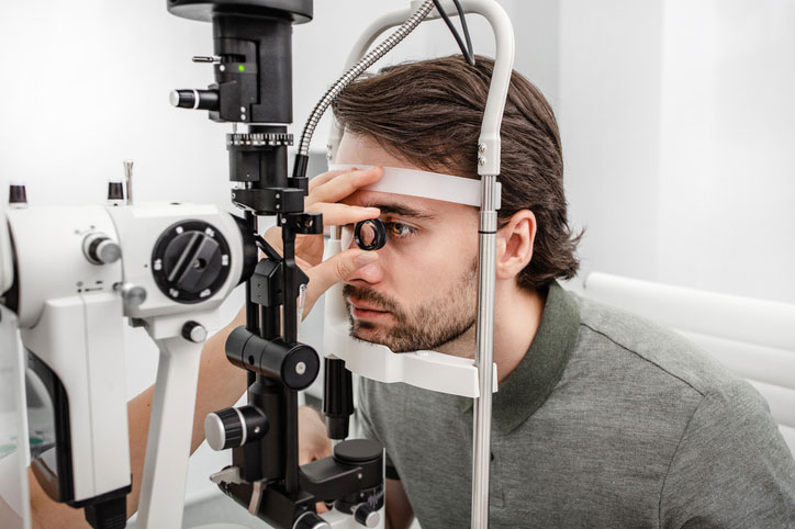 Patient undergoes an in-office eye exam with advanced diagnostic equipment while exploring LASIK alternative vision correction options.
