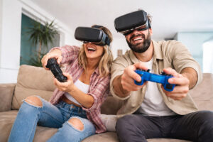 Couple with wearable tech devices, playing VR games at home after guidance from Wellish Abrams Vision Institute.