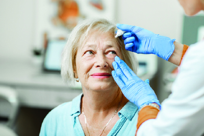 Imagery of a glaucoma patient having a dose of eye drop medication.