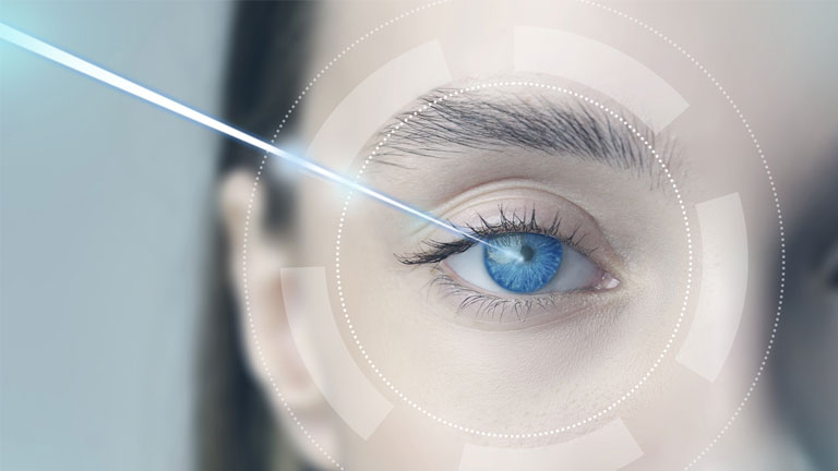 Close-up of a human eye with digital laser technology scanning the iris, symbolizing LASIK and modern eye care innovation.