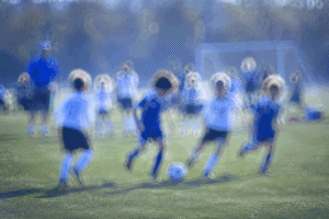 Children's soccer game through blurred vision from cataracts can be treated at Wellish Abrams Vision Institute.
