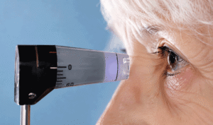 Senior woman having a tonometry test to measure eye pressure, representing glaucoma screening at Wellish Abrams Vision Institute.