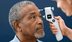 Black senior man having eye pressure measured during a glaucoma screening exam at Wellish Abrams Vision Institute.