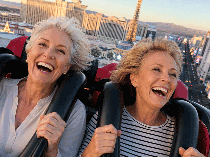 Two women enjoying a rollercoaster in Las Vegas, representing active lifestyle goals for patients asking is LASIK safe at Wellish Abrams Vision Institute.