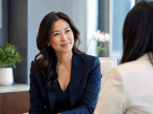 Professional woman speaking with an employee in a modern office, illustrating workplace wellness and ways to reduce glaucoma risk for Wellish Abrams Vision Institute.